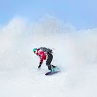 Ein Snowboarder genießt eine Abfahrt während seinem Privaten Snowboardkurs für Kinder & Erwachsener für Anfänger mit EasySki Saalbach.