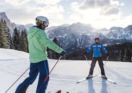 Adult skier with their instructor during Adults Ski Lessons for All Levels - DOLOMITES from Scuola di Sci e Snowboard Dolomites Armentarola .