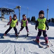 Three little skiers on the slope during their Kids Ski Lessons (6-13 y.) for Advanced Skiers from Ski school & Rental Sportwelt Oberhof.