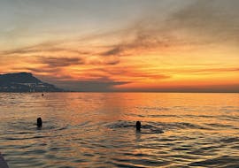 People during their swimming stop watching the sunrise during their Sunrise RIB Boat Trip to Saint-Jean-Cap-Ferrat from Nice with Breakfast from Nissa Croisières.