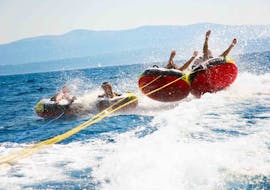 A group of friends enjoy a Banana Boat and Crazy Sofa Rides at Anassa Beach from Latchi Dive & Watersports Centre.