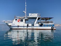 A boat is floating on the ocean while Boat Rental in Krk (up to 12 people) organized by Styria Guenis Diving Center Krk.