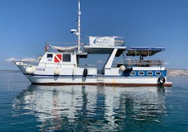 A boat is floating on the ocean while Boat Rental in Krk (up to 12 people) organized by Styria Guenis Diving Center Krk.