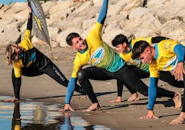 Stretching exercise during Surf Lessons (from 6 y.) in Costa da Caparica from Portugal Surf School Costa da Caparica.