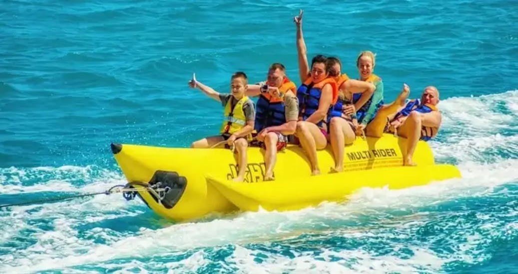 Group of people enjoying in Villajoyosa in the banana boat ride activity of Todajet