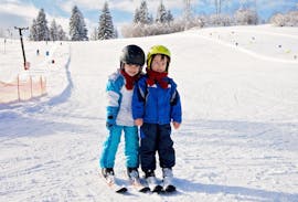 Two children attending the private kids ski lessons for all ages from Ben&Joe's Private Ski & SB School Davos in Davos.