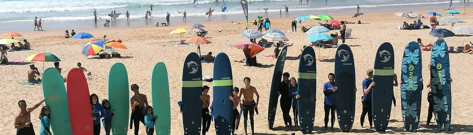 People on the Beach Holding Surf Boards During Surf Lessons (from 8 y.) on Praia Grande.