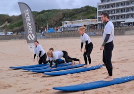 People Doing Warm-up Exercises During Private Surf Lessons (from 8 y.) on Praia Grande from Soul Spot Surf School Praia Grande.