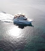 A boat is driving to its next destination while Boat Trip from Malia to Stalis & Hersonissos with Swimming Stops & Snorkeling organized by Malia Cruises.
