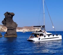 Un parada para bañarse durante un Paseo en catamarán por la costa de Santorini al Volcán con almuerzo con Santorini Sailing Star Luxury.