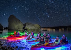Group of people in the kayak with the lights under it during the Night Glow Kayaking tour in Pag Bay from Ručica Beach from Sunturist Novalja.