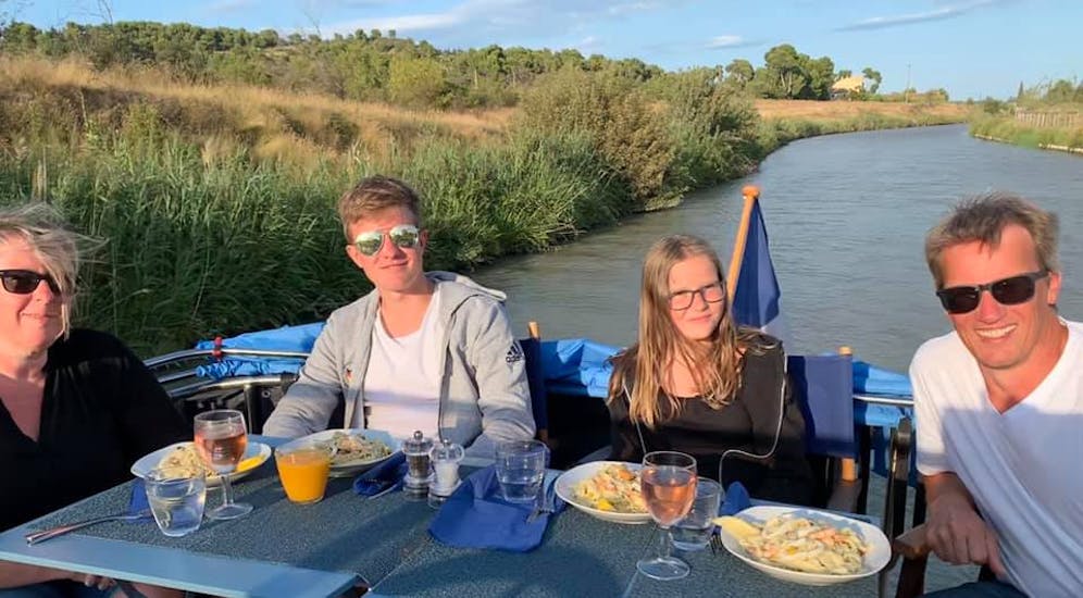 4 people in a private day Exclusive cruise currently eating diner at sunset on canal du midi.