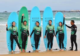A group of friends showing their board during their Surf Lessons on Peniche beach with G3Store Surf Center Peniche.