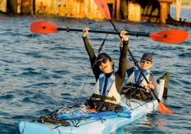 Two participants cheering on their kayak during the Sunset Sea Kayak Tour around Kissamos Bay with Swimming from Sea Kayak Kissamos.