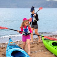 A kid smiling with a paddle in the hand during the Sea Kayak Tour around Kissamos Bay for Families from Sea Kayak Kissamos.
