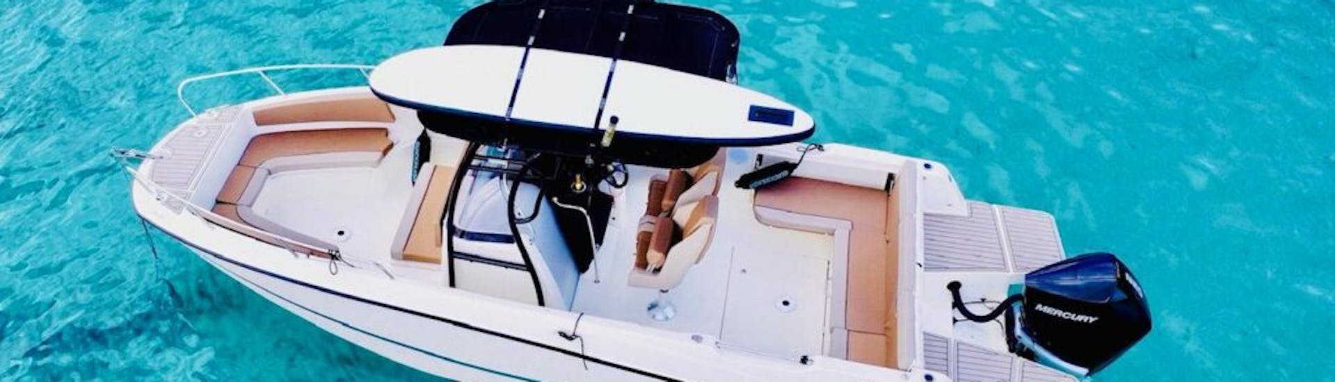 Top view of private boat within the clear waters of Mallorca with MiniBar&co