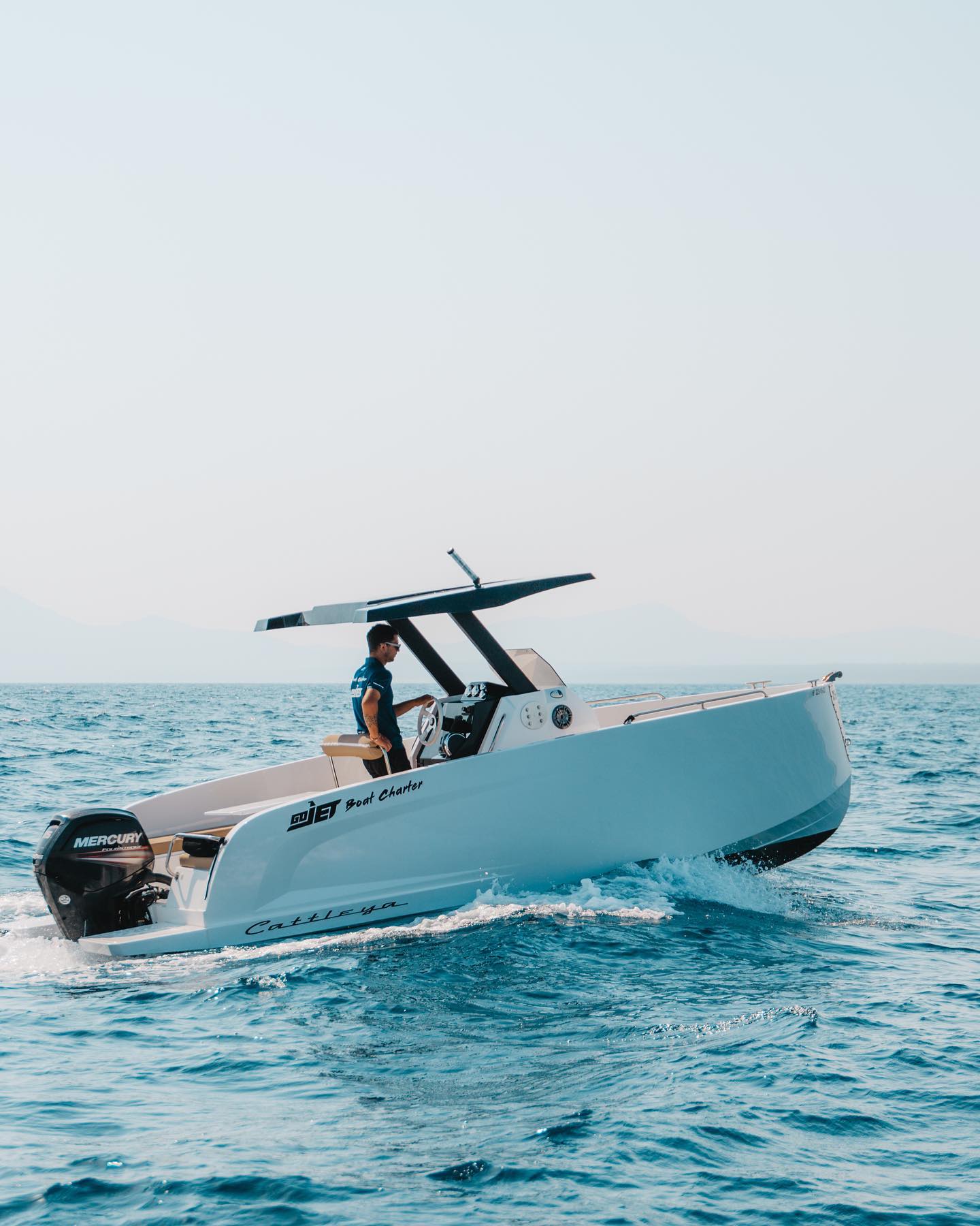 Boat Rental standing in a blue and trasnparent water in Alcúdia with license from GoJet Jet Ski Mallorca.