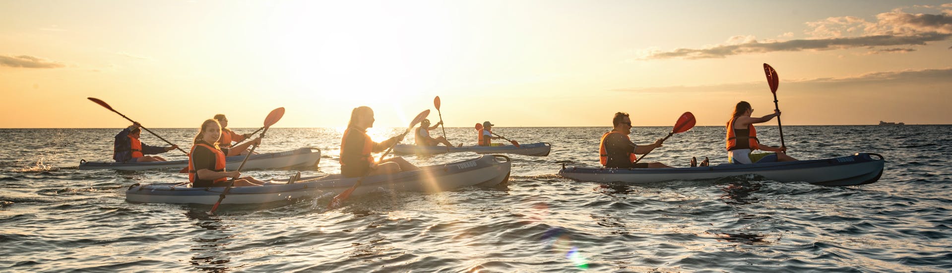 A group of people in their kayaks during their Sunset Sea Kayak Tour in Piran.