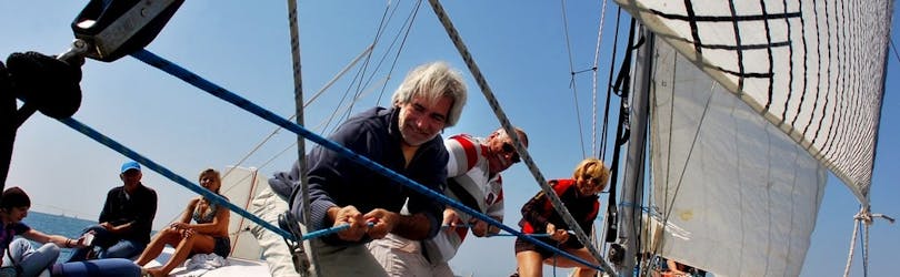 Clients maneuvring the catamaran during the Private Catamaran Trip on Grau-du-Roi Coasts from Voilemed.