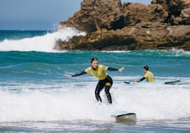 Person Riding a Wave During Surf Lessons (from 6 y.) on Praia da Rocha from Future Eco Surf School.