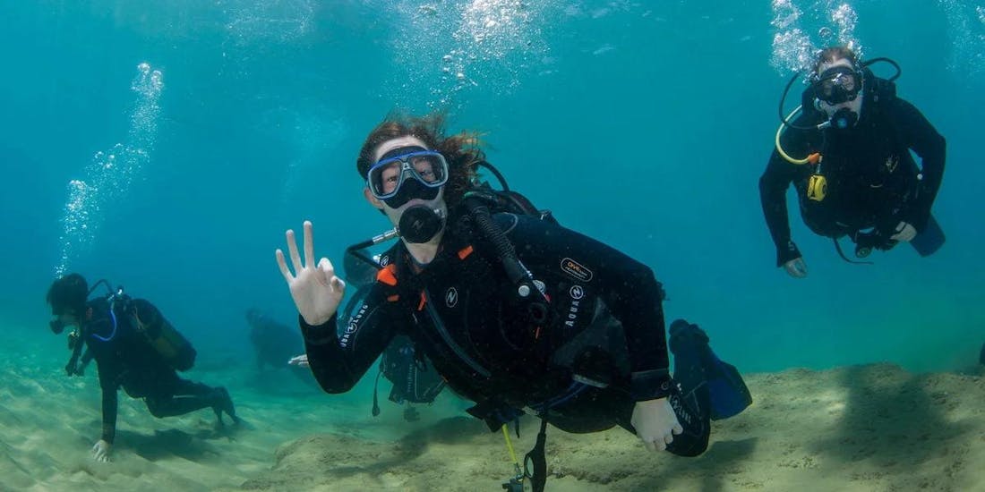 Three people diving during their PADI Discover Scuba Diving - Intro in Crete.