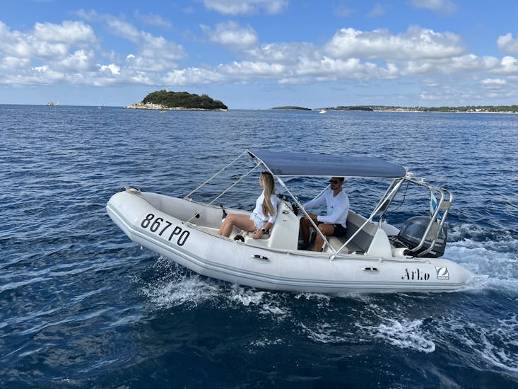 A couple enjoying their boat drive during the Boat Rental in Istria (up to 5 people) by Istra Speed Boat.