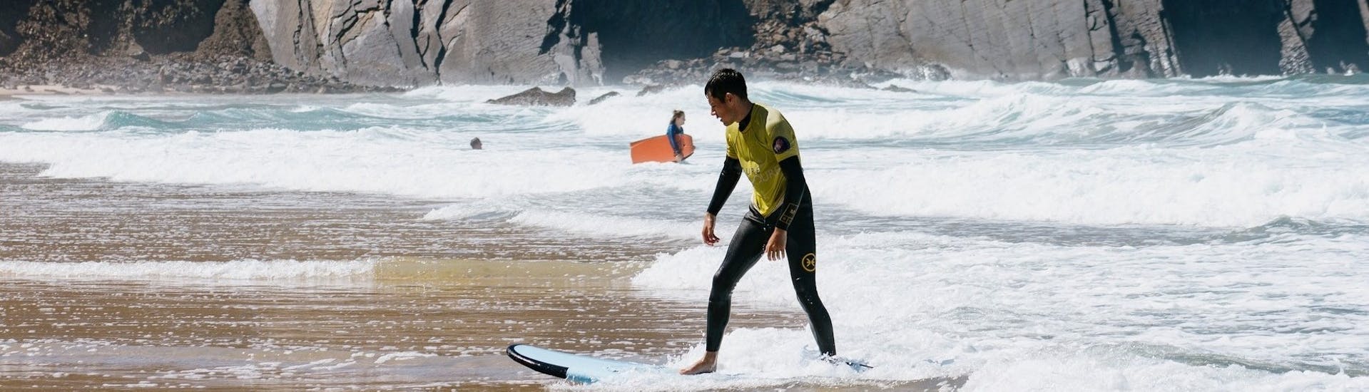 Guy on Beach with Surfboard During Private Surf Lessons (from 8 y.) in Costa Vicentina by Future Eco Surf School.