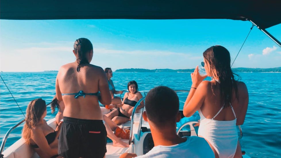 People relaxing on the boat during the Private Boat Trip around the Lim Fjord and Rovinj with Swimming and Snorkeling.