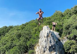 A man jumping off a cliff during the Boat Trip in Istria with Snorkeling and Cliff Jumping from Istra Speed Boat.