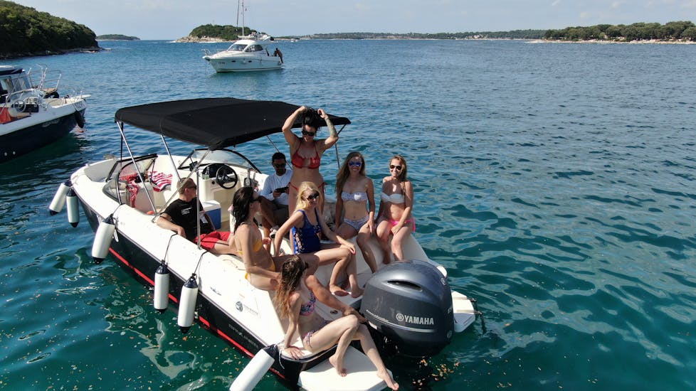 A group relaxing on the boat during the Private Boat Trip in Istria with Snorkeling and Cliff Jumping.