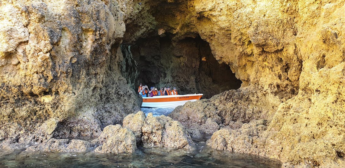 The small boat in a cave during the Private Boat Trip to the Caves of Ponta da Piedade.
