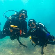 Underwater image of two certified divers posing for the camera while enjoying their guided dive with WeDive Lagos.