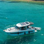 A boat on the azure water of the Adriatic Sea during the Private Boat Trip from Umag to Poreč and Rovinj with Swimming and Drinks from Sea la Vie Charter Umag.