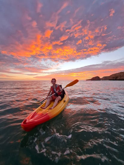 A woman enjoying our private Sunset Kayak Tour to the Benagil Caves and Marinha beach from Albandeira from Albandeira Ecotours.