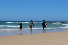 People walking on the beach during the private surf lessons in Vila Nova de Milfontes organized by SurfMilfontes.