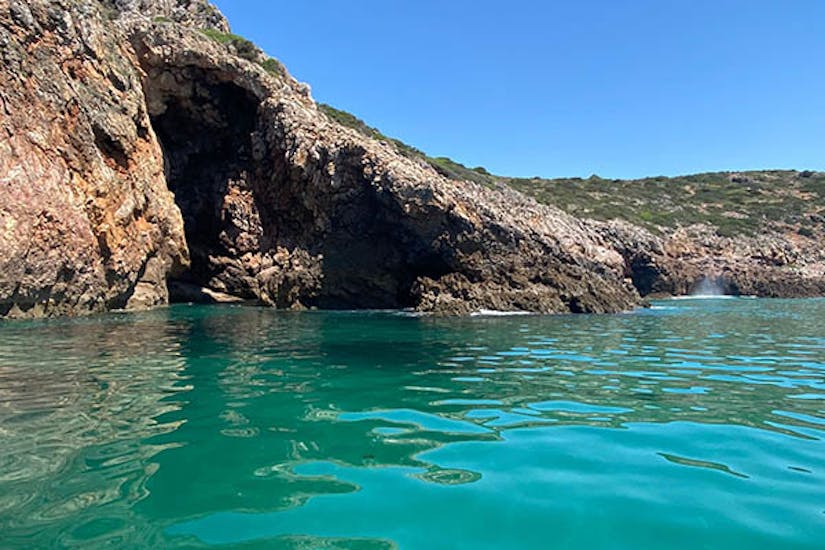 The caves from the outside surrounded by clear blue water during the Boat Trip to Secret Caves in Costa Vicentina Natural Park from Cape Cruiser Sagres.