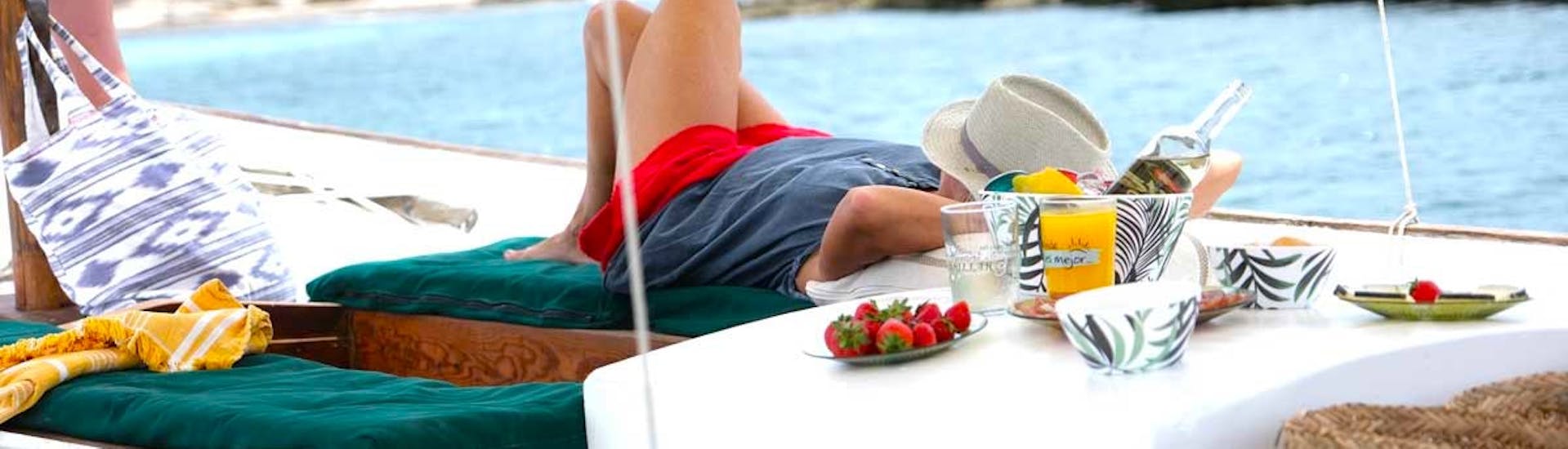 Man lying on the Rapita Charter Boat "Sol" during his private boat trip in Mallorca