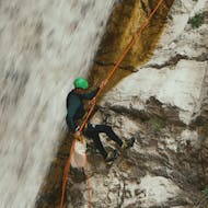 Person abseiling from steep rock during Canyoning in the Nefeli Canyon for Intermediates from Active Nature Epirus.