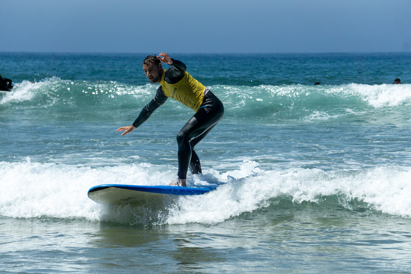 A surf instructor in the water during surf lessons in Lagos organized by Algarve Watersports.