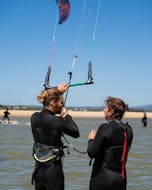 An instructor and a student during the private kitesurfing lessons in Lagos organized by Algarve Watersports.