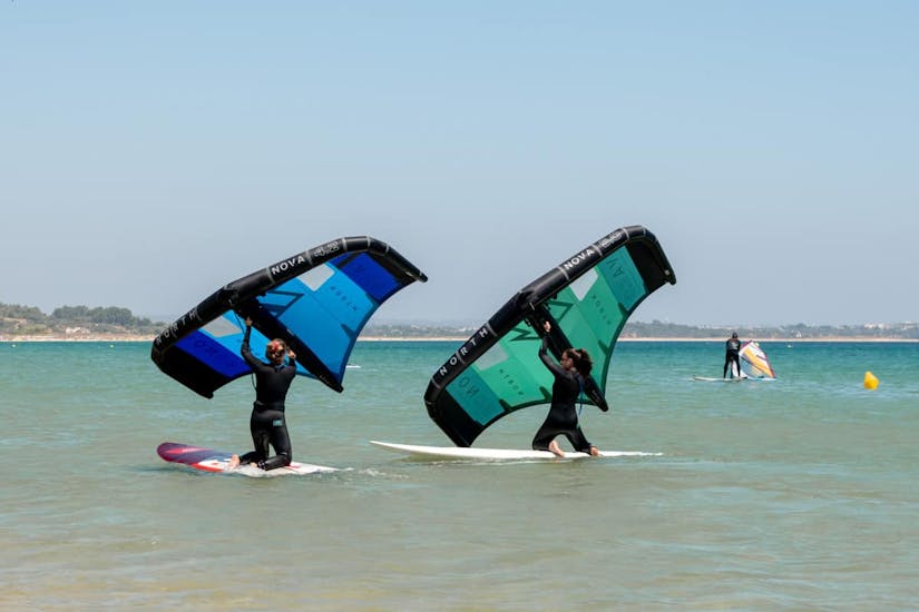 Two people during the semi private wingfoiling lessons organized by Algarve Watersports.