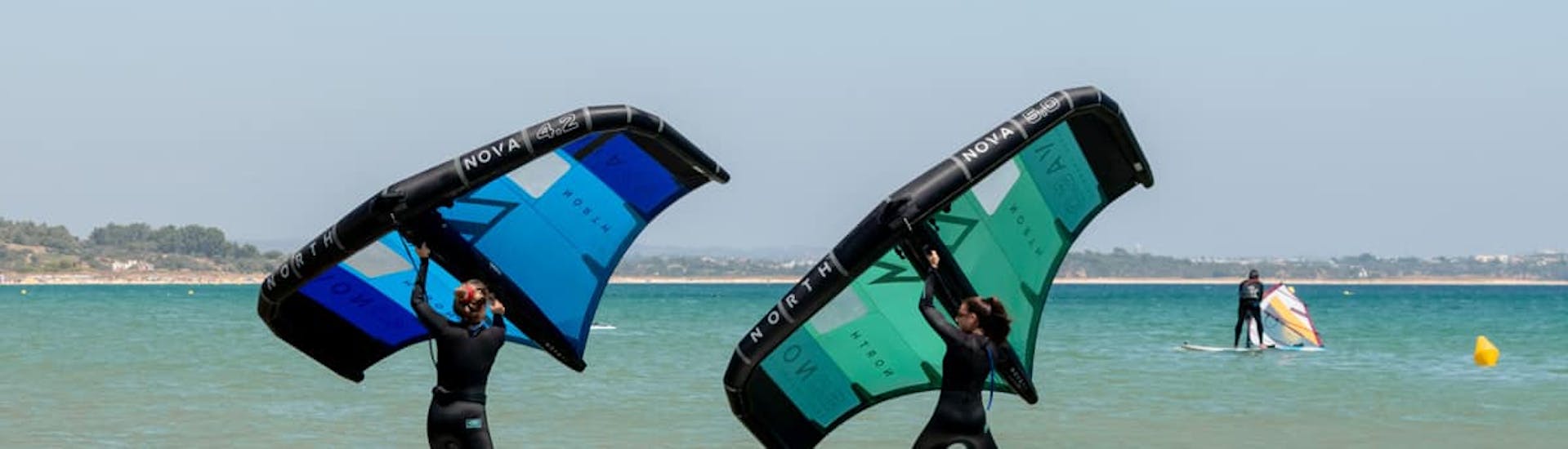 Two people during the semi private wingfoiling lessons organized by Algarve Watersports.