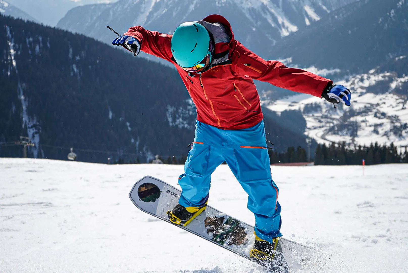 private-snowboarding-lessons-for-kids-and-adults-of-all-levels-top-secret-ski-und-snowboard-school-davos A snowboarder is doing jumps during private snowboarding lessons for kids and adults of all levels with Top Secret ski school in Davos.