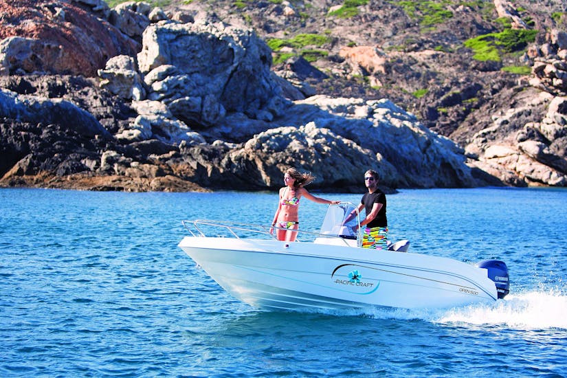 2 people driving on a boat during a Boat rental in Sète (up to 5 people) - with License.