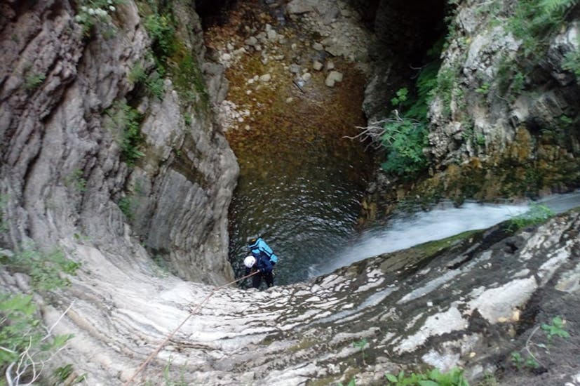 A participant abseiling during the Canyoning in the Papapidima Gorge in Tzoumerka with Via Natura Rafting Tzoumerka.