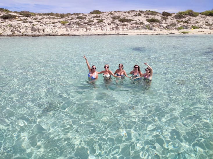 Five girls posing for a photo after having enjoyed a catamaran trip with Blue Charter Ibiza.