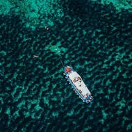 Aerial perspective of a boat, anchored in turquoise blue water during an island picnic boat trip from Korčula (town) from Korkyra Info.