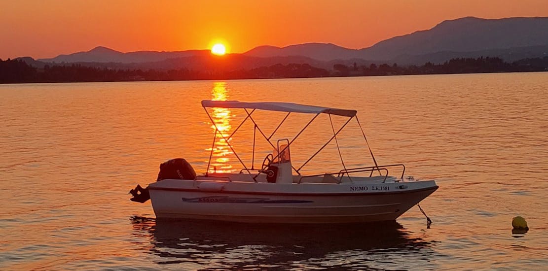 The boat during sunset during the Boat Rental in Corfu (up to 4 people) without Licence from Corfu Surf Club.
