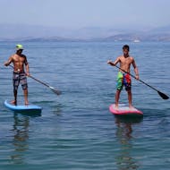 People on their SUPs during their SUP Rental at the Alykes Potamos Beach in Corfu from Corfu Surf Club.