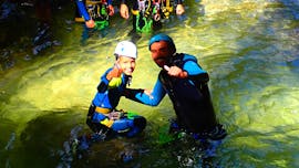 A dad and his kid having fun during the Canyoning in the Upper Canyon du Furon for Beginners from Terra Nova Canyoning.